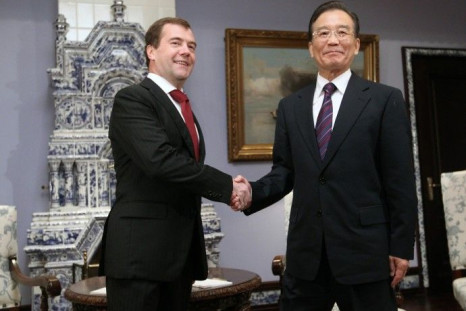 Russia's President Medvedev shakes hands with China's Premier Wen Jiabao during their meeting at the presidential residence in Gorki outside Moscow