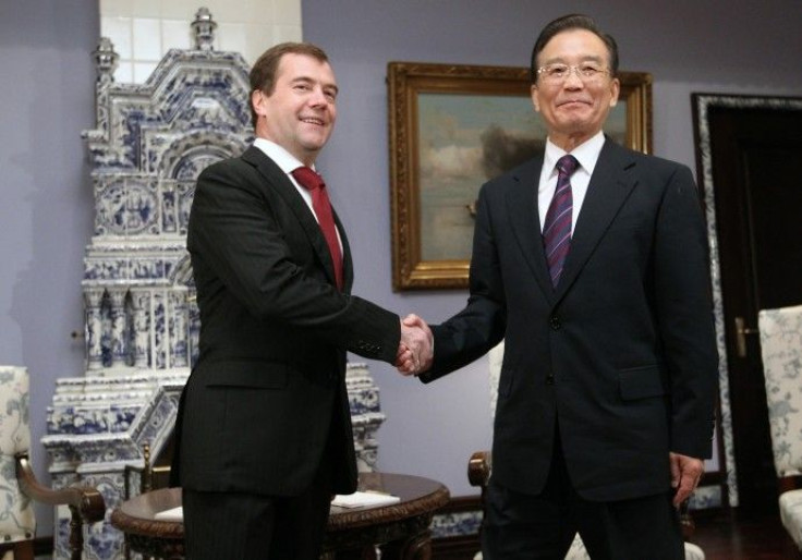 Russia's President Medvedev shakes hands with China's Premier Wen Jiabao during their meeting at the presidential residence in Gorki outside Moscow