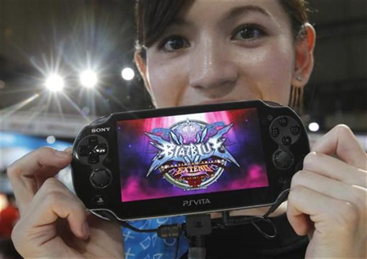 A promotional woman shows a Sony&#039;s PlayStation Vita handheld gaming device at Tokyo Game Show in Chiba