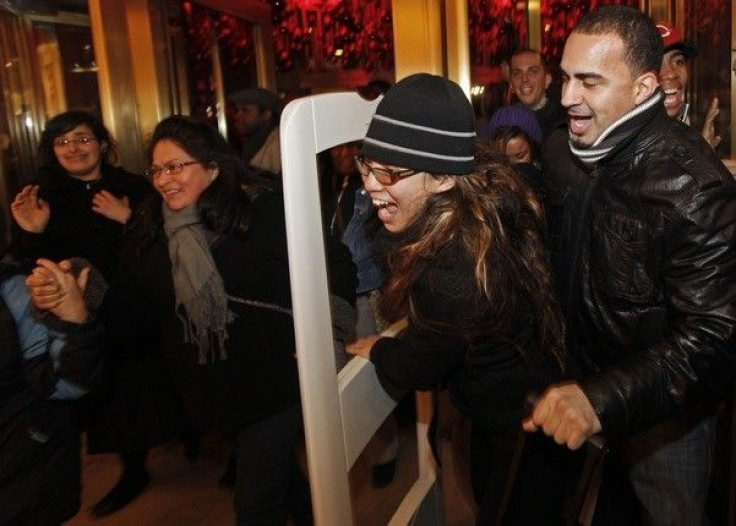 Shoppers rush through the doors of Macy's at 5a.m. ET in search of Black Friday bargains in New York, November 27, 2009. 