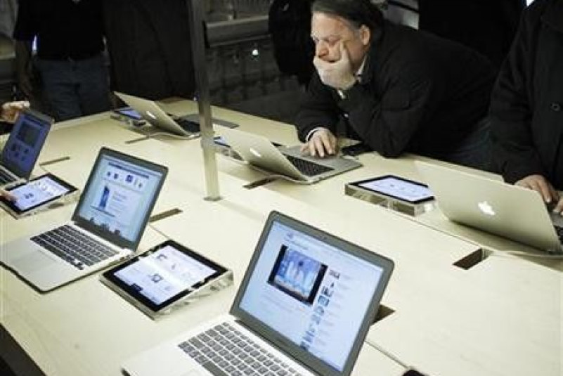 People look at Apple products inside the newest Apple Store during opening on the East Balcony in the main lobby of New York City's Grand Central Station December 9, 2011.