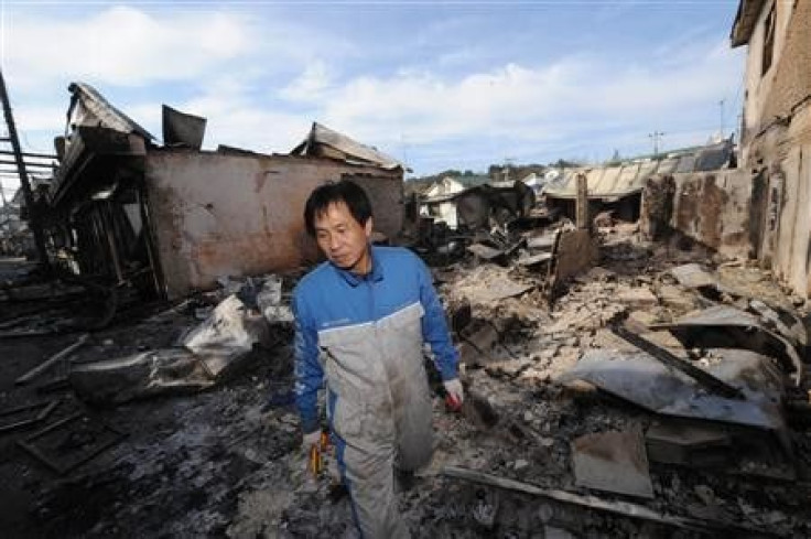 A local resident looks around damaged houses on Yeonpyeong Island 