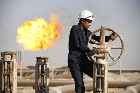 A worker adjusts the valve of an oil pipe at West Qurna oilfield in Iraq's southern province of Basra November 28, 2010