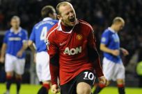 Manchester United's Rooney celebrates scoring a penalty kick during their Champions League soccer match against Rangers in Glasgow, Scotland.