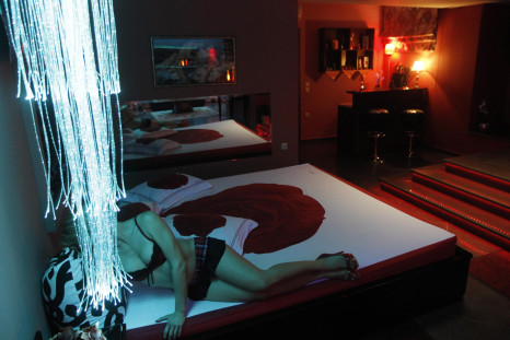 Sex worker poses in room in "Soula", a luxury brothel which sponsors the local soccer team.