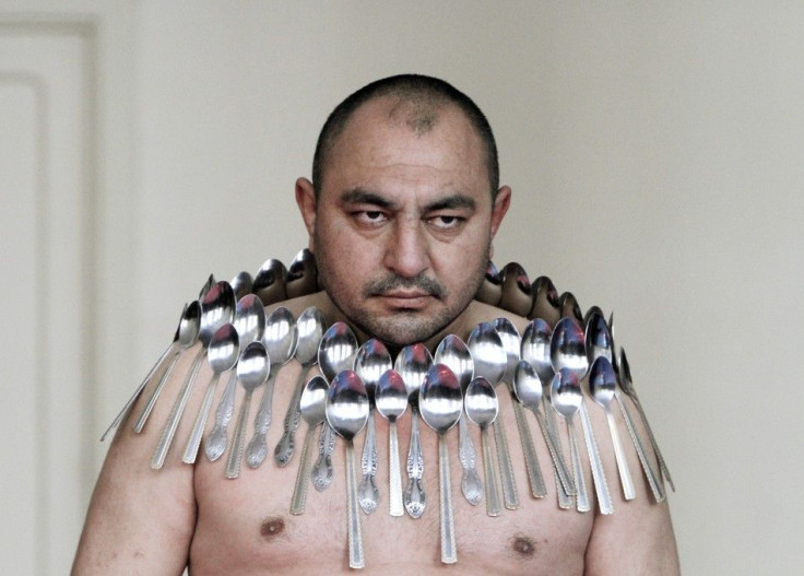 Etibar Elchyev poses with 50 metal spoons magnetized to his body during an attempt to break the Guinness World Record for