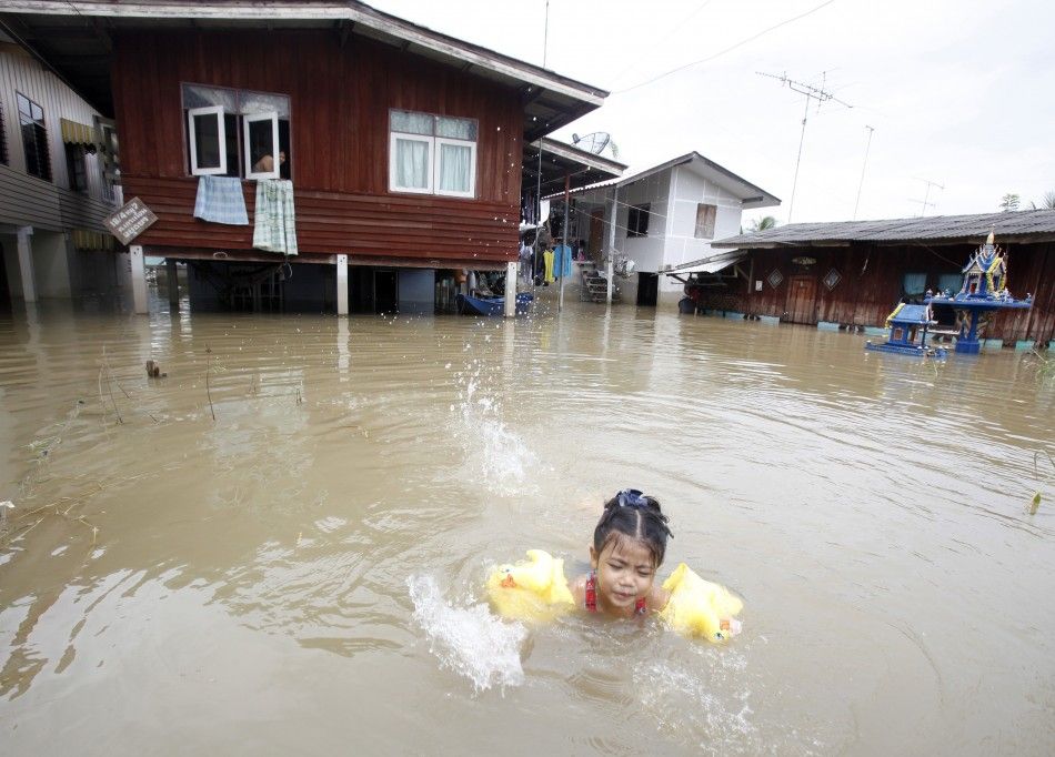 Child swimming in flood water