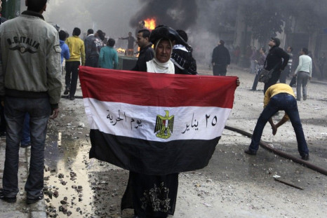 A pro-democracy activist holds the Egyptian flag amidst Cairo violence on Friday.