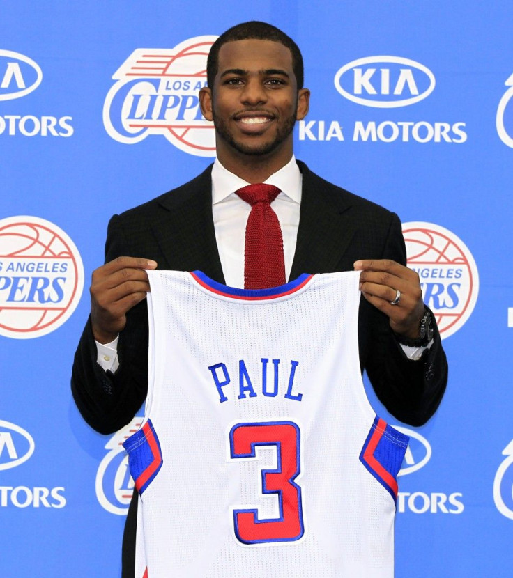Los Angeles Clippers point guard Chris Paul poses with his new jersey after an introductory news conference in Playa Vista, Los Angeles, California 
