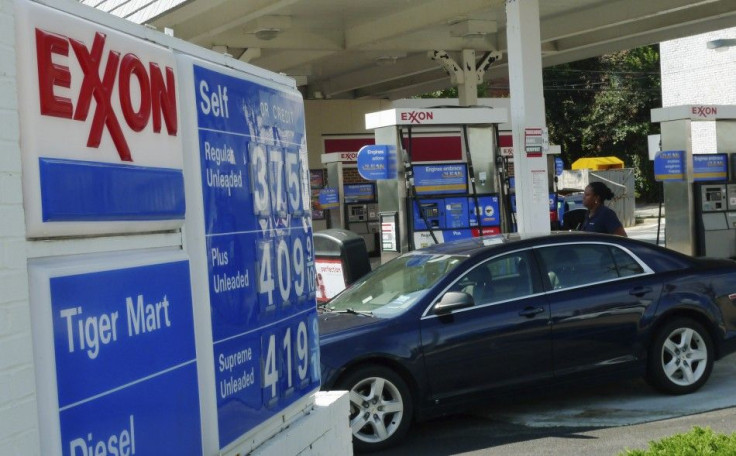 A motorist fills up her tank with gas at an Exxon gas station in Arlington