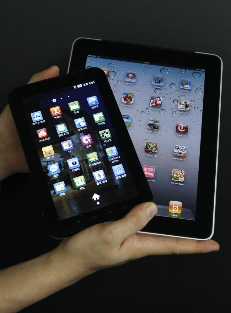 An Apple Inc's iPad 2 tablet and a Samsung Electronics' Galaxy Tab tablet are seen in this picture illustration taken in Seoul