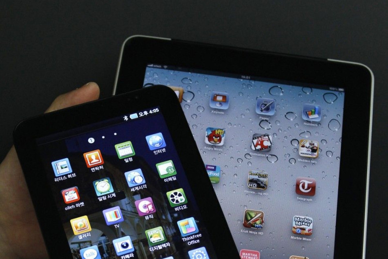 An Apple Inc's iPad 2 tablet and a Samsung Electronics' Galaxy Tab tablet are seen in this picture illustration taken in Seoul