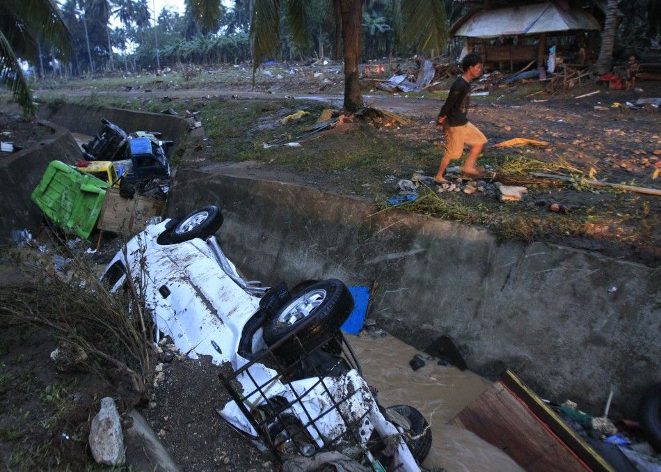 Damaged vehicles swept away by flashfloods caused by typhoon Washi lie in a ditch in Balulang village in Cagayan de Oro, southern Philippines 