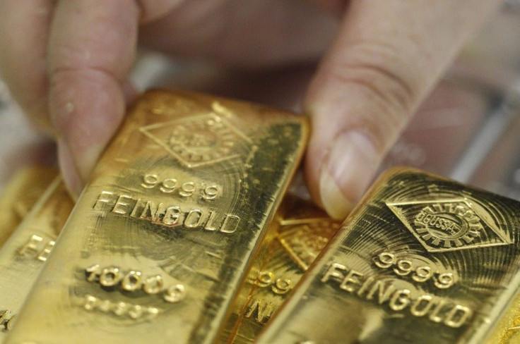An employee picks up a gold bar at the Austrian Gold and Silver Separating Plant 'Oegussa' in Vienna August 26, 2011.
