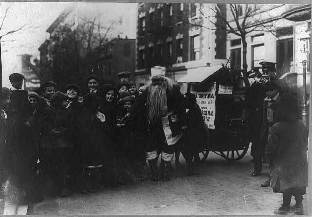 Santa Claus and Salvation Army musicians entertaining children on NYC street