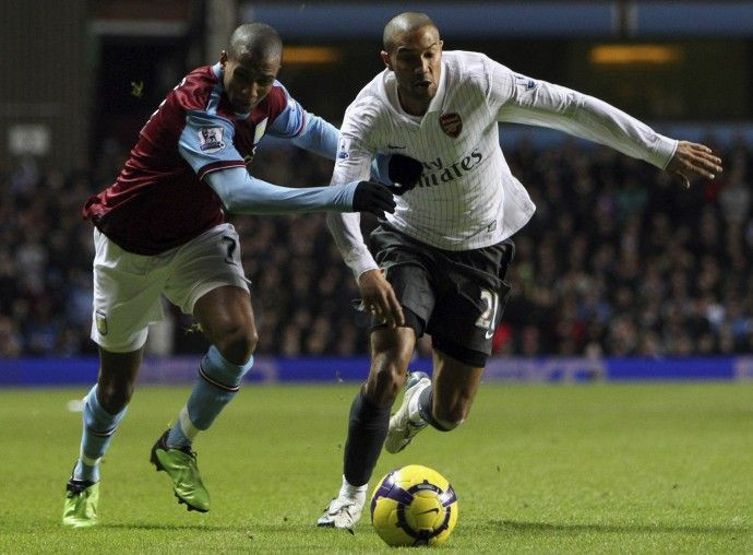 Arsenal's Clichy holds off Aston Villa's Young during their English Premier League soccer match in Birmingham.