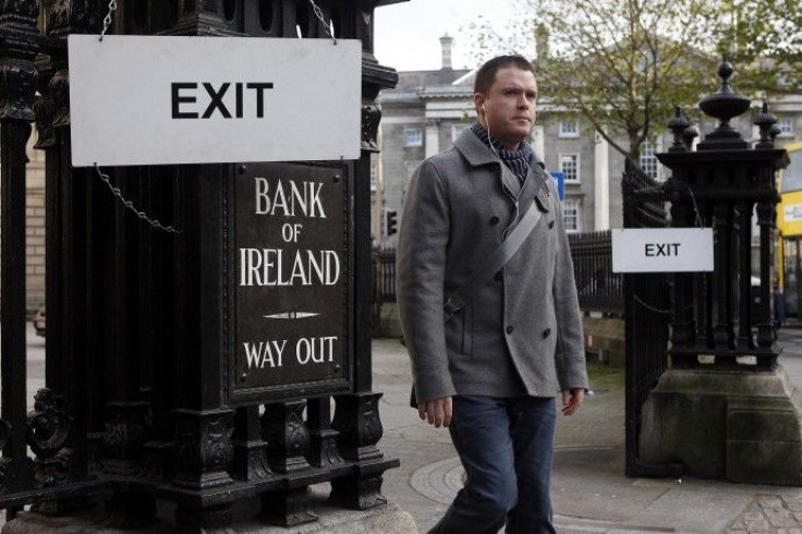 A pedestrian leaves the Bank Of Ireland headquarters in central Dublin