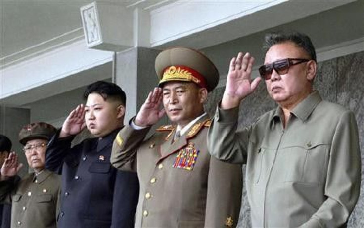 North Korean leader Kim Jong-il (R) and his son Kim Jong Un (3rd R) salute as they watch soldiers attending a military parade in the Kim Il Sung square in Pyongyang