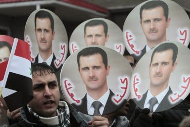 A Syrian citizen takes part in a rally in support of President Bashar al-Assad in front of the Syrian embassy in Minsk