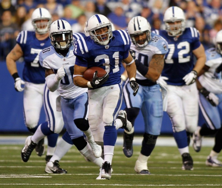 Indianapolis&#039; Donald Brown runs from Tennesee&#039;s defense during an NFL football game in Indianapolis