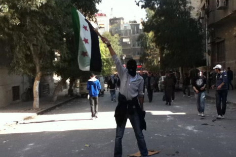 A demonstrator protests against Syria&#039;s President Bashar al-Assad in Damascus
