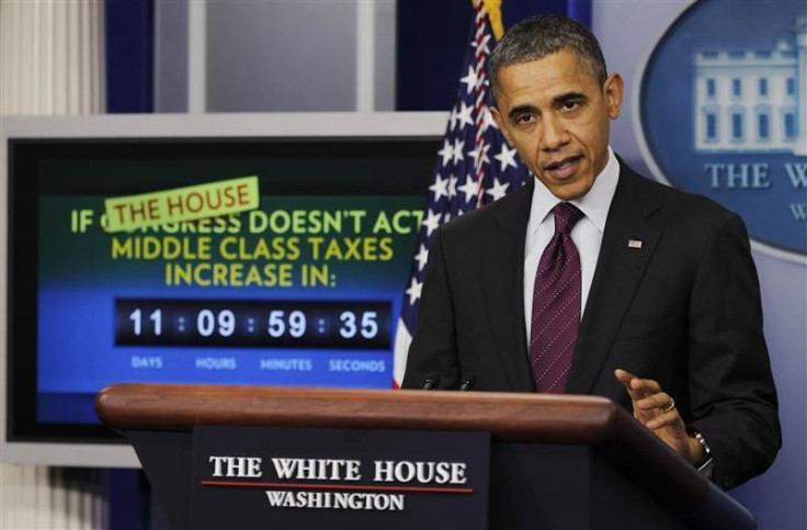 U.S. President Barack Obama is pictured alongside a tax law count down clock in the White House Briefing Room