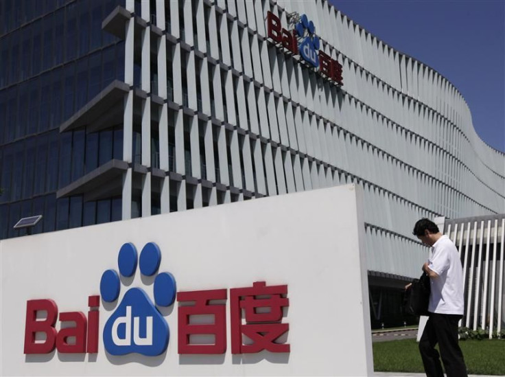An employee walks past the Baidu company signage outside its headquarters in Beijing