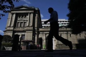 A man walks past the Bank of Japan headquarters building in Tokyo