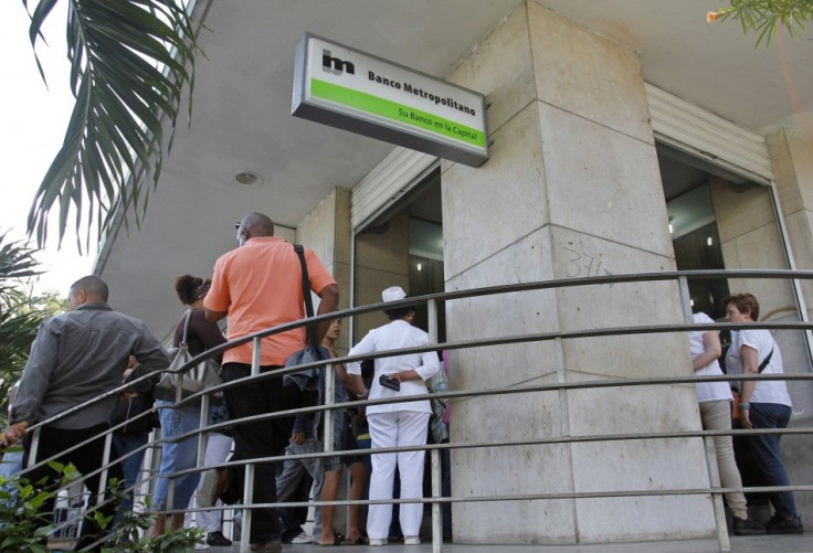 Cubans line up outside a bank in Havana