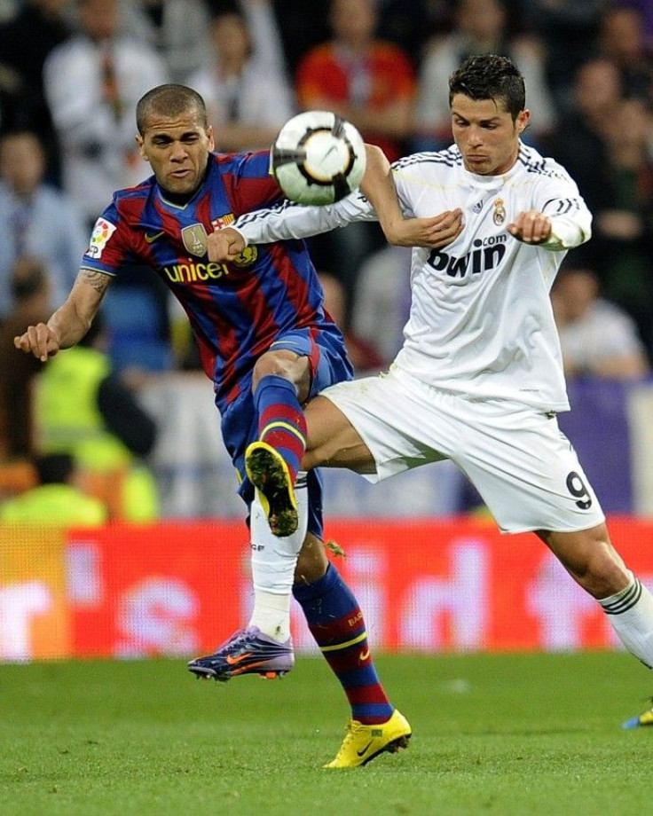 Real Madrid's Ronaldo battles for the ball against Barcelona's Alves during their Spanish first division soccer match in Madrid on 10/04/2010.