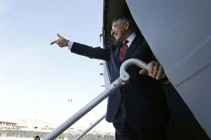 U.S. Secretary of of Defense Leon Panetta gestures as he prepares to depart Tripoli