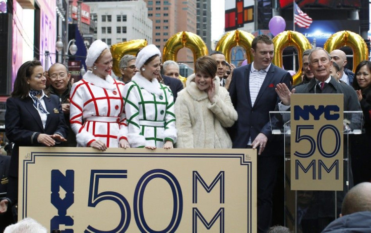 New York City Mayor Michael Bloomberg presents Craig Johnson and his wife Lucy Johnson from Lichfield England with a &quot;Golden Ticket&quot; as the city&#039;s honorary 50 millionth visitors for 2011 during a ceremony in Times Square, New York