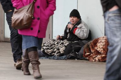 A homeless man sits on the pavement in central London