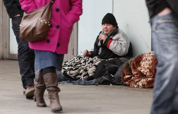 A homeless man sits on the pavement in central London