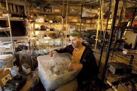 Trent Arsenault looks at his supply of specimen cups at his home in Fremont, California