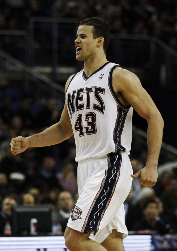 New Jersey Nets' Humphries celebrates after scoring in the 4th quarter of the NBA game against the Toronto Raptors in London