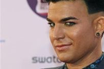 U.S. singer Adam Lambert poses on arrival on the red carpet at the MTV Europe Music Awards show in Belfast