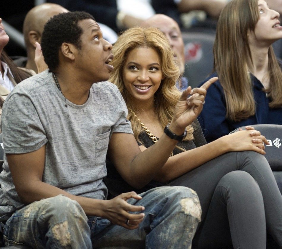 Jay Z and his wife Beyonce watch the New Jersey Nets play the Phoenix Suns in their NBA game in Newark