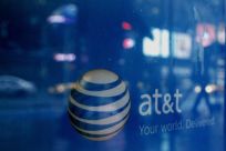 Reflections are seen in the window of an AT&T store in New York