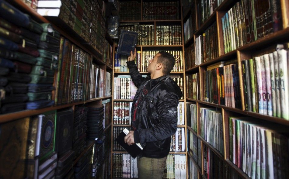 A man browses a selection of Islamic books at a shop in the old city of Cairo