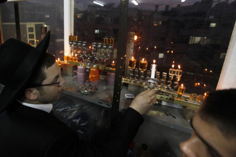 A Jewish seminary student lights a candle for Hanukkah in Ashdod