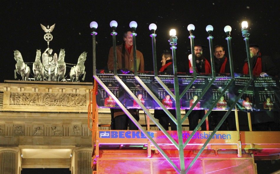 Rabbi Yehuda Teichtal lights a giant menorah during a ceremony in front of the Brandenburg Gate in Berlin