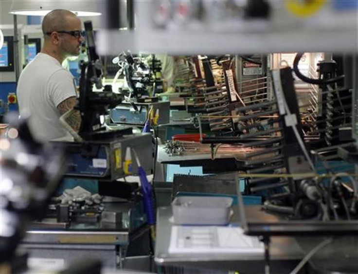 A worker does quality checks on razor blades manufactured at Gillette&#039;s factory in Boston