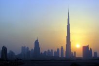 The Burj Khalifa is seen as the sun sets over Dubai