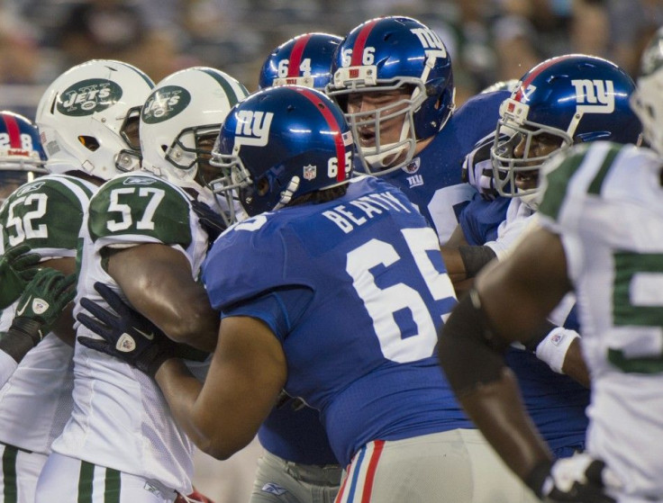 New York Giants Will Beatty and David Diehl separate New York Giants Brandon Jacobs and New York Jets Bart Scott in East Rutherford