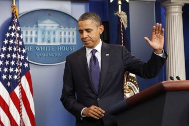 U.S. President Barack Obama waves good-bye after speaking about the passing of the payroll tax cut extension at the White House in Washington December 23, 2011.