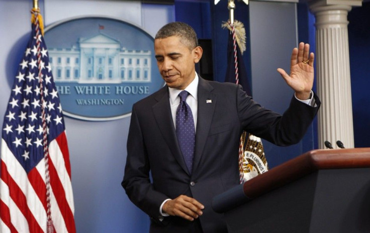 U.S. President Barack Obama waves good-bye after speaking about the passing of the payroll tax cut extension at the White House in Washington December 23, 2011.