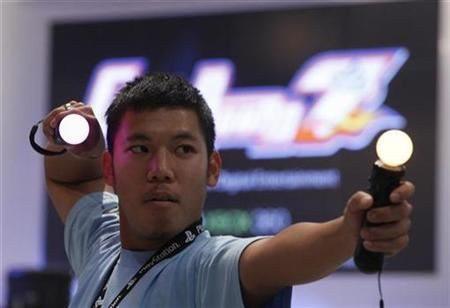 A visitor plays with the new PlayStation Move-Motion-Controller at their exhibition stand at the Gamescom 2010 fair in Cologne