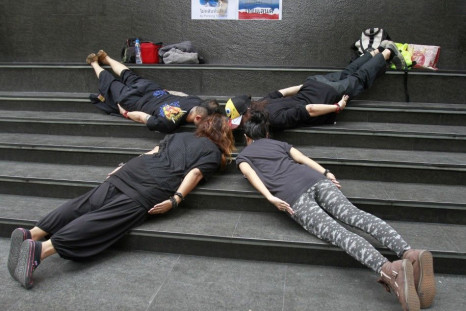 Members of a group called &quot;Planking Thailand&quot; make a cross formation, to urge people to vote, a day before advance voting commences in Bangkok June 25, 2011.
