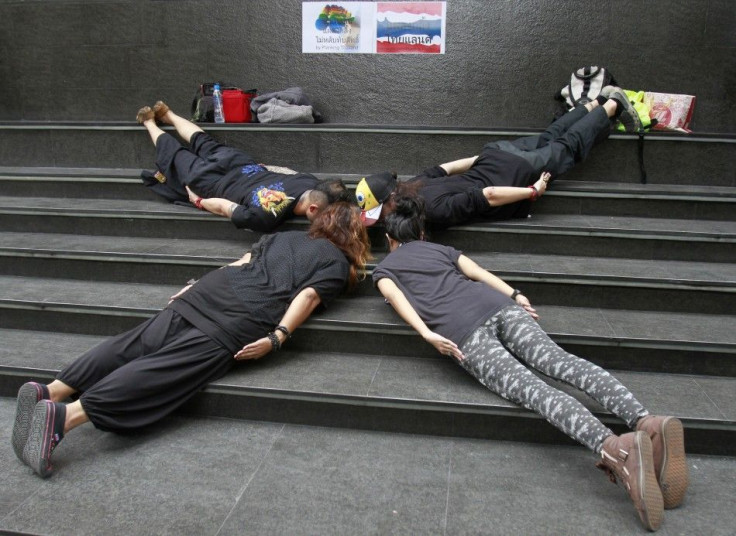 Members of a group called &quot;Planking Thailand&quot; make a cross formation, to urge people to vote, a day before advance voting commences in Bangkok June 25, 2011.